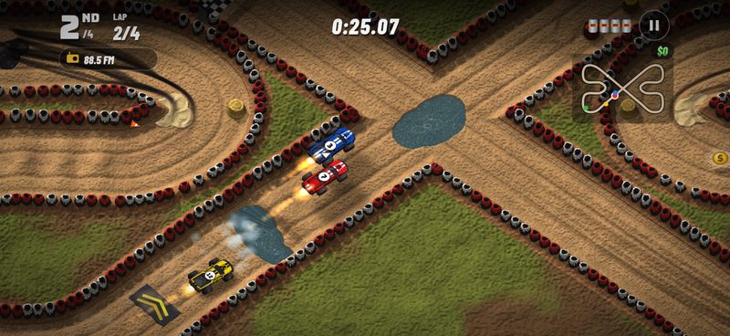 Blue and red trucks fire their nitro toward an X-shaped crossing while the yellow truck boosts away from a chevron boost pad past a water splash